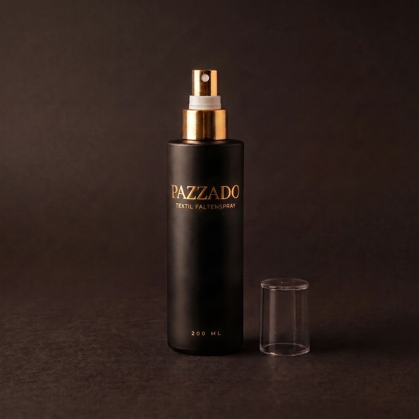PAZZADO Textil-Faltenspray, 200 ml, mattschwarze Flasche mit goldenem Sprühkopf vor dunklem Hintergrund.